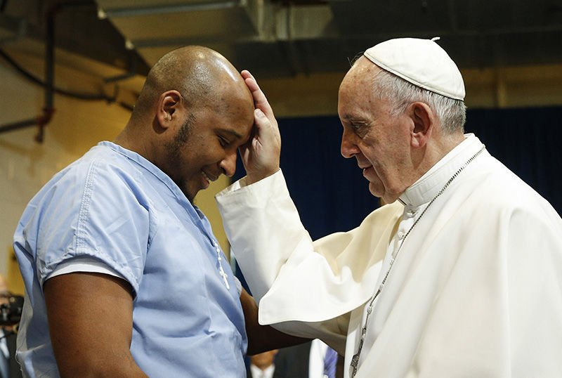 Pope Francis has pointed out that prisoners are not to be made “scapegoats” for society’s ills. He’s seen here blessing a prisoner as he visits the Curran-Fromhold Correctional Facility in Philadelphia Sept. 27. (Paul Haring/CNS)