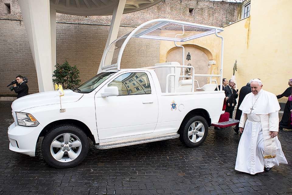 Pope Francis before a Popemobile at the Vatican