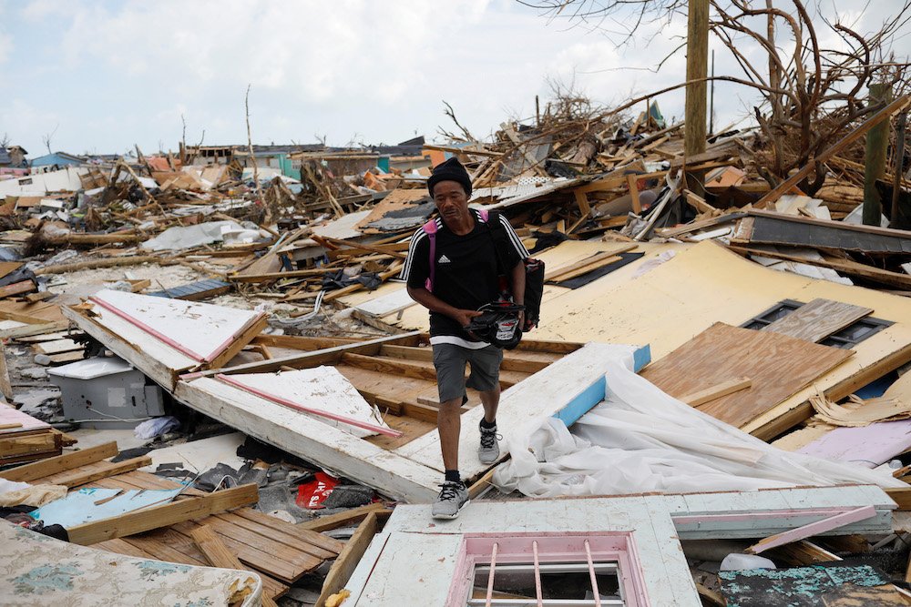 A man walks amid the rubble of destroyed homes Sept. 6