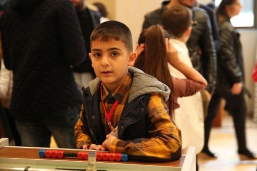 Young refugees play games as they wait for Pope Francis to visit in Istanbul