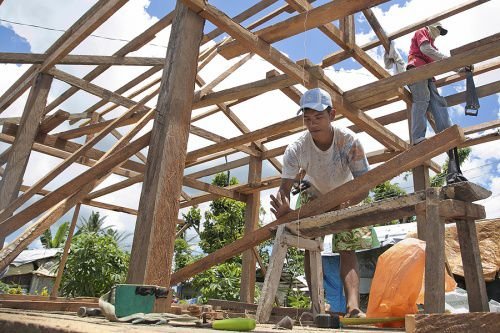 Men work on rebuilding homes in Visayas