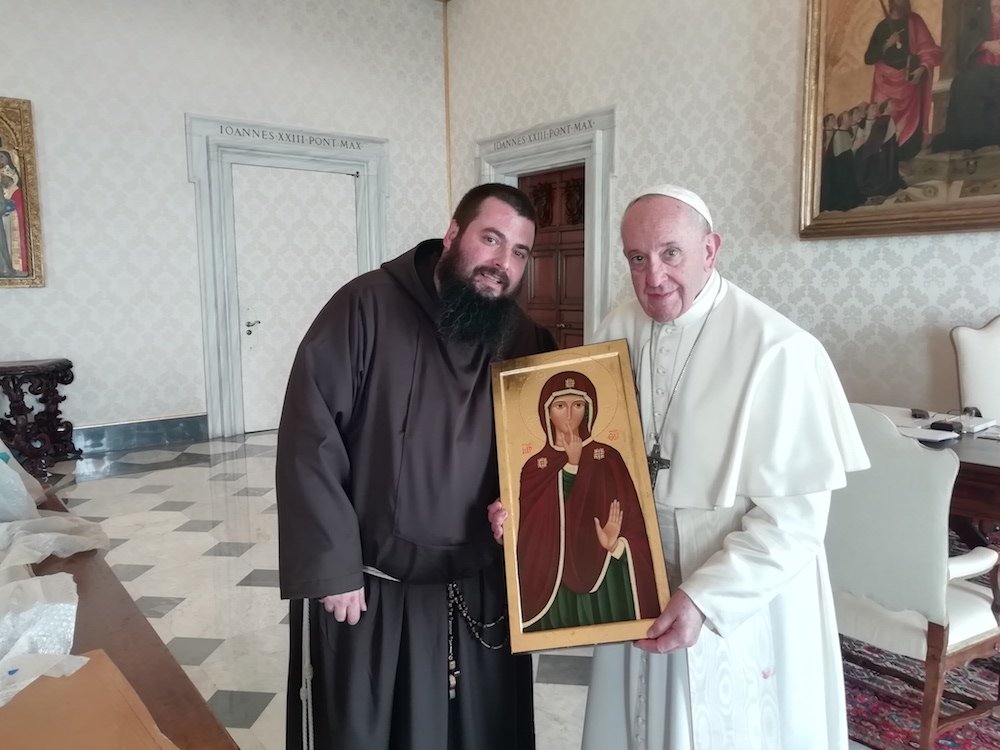 Capuchin Father Emiliano Antenucci presents an image of Our Lady of Silence to Pope Francis at the Vatican March 22