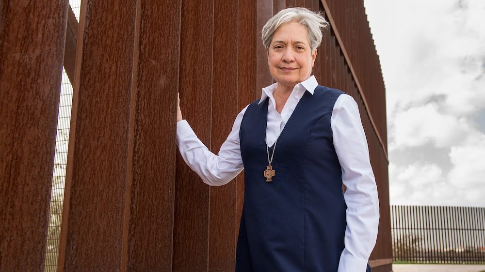 Sister Norma Pimentel, a member of the Missionaries of Jesus, is pictured along a border wall in late February. She is the executive director of Catholic Charities of the Rio Grande Valley in the Diocese of Brownsville, Texas. (CNS photo/Barbara Johnston, courtesy University of Notre Dame)