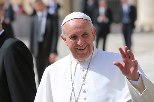Pope Francis waves to the general audience on April 1