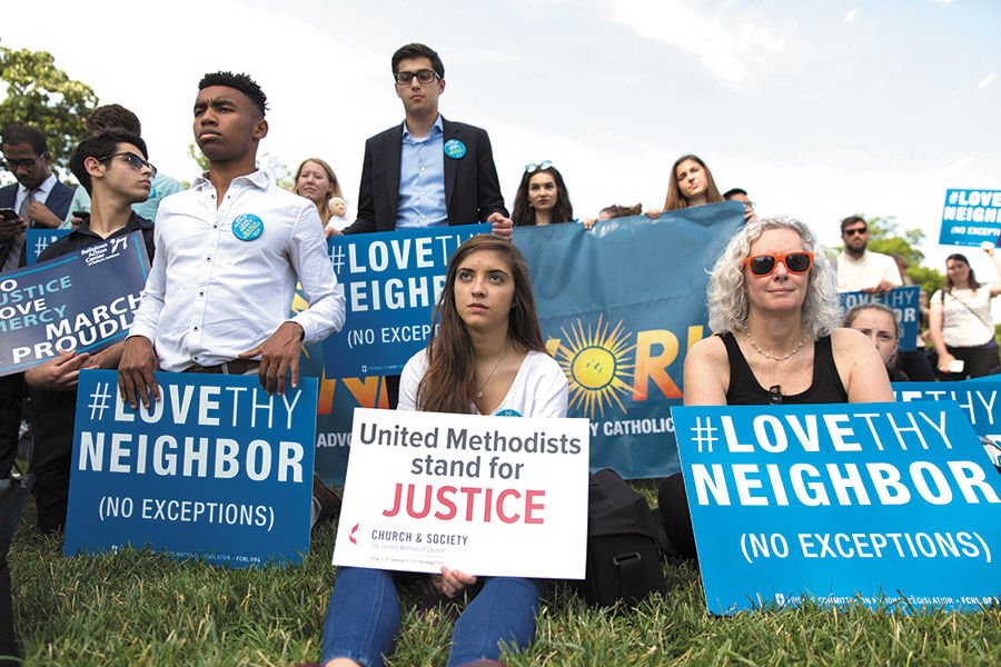 People hold signs during the launch of a 23- hour prayer vigil June 29 on Capitol Hill in Washington. The vigil focused on preserving Medicaid and was organized after the Senate delayed a vote on the Better Care Reconciliation Act
