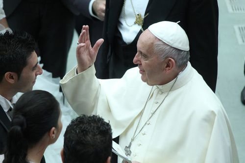 Pope Francis greets a newly married couple at general audience in Paul VI Hall on Aug. 19