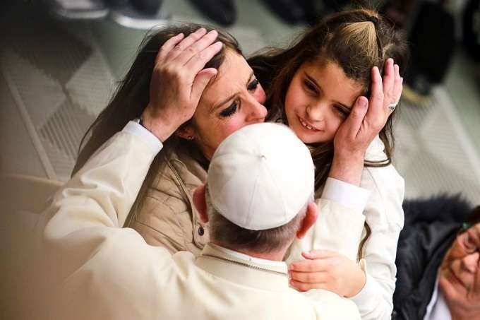 Pope Francis greets pilgrims during his general audience Jan. 13