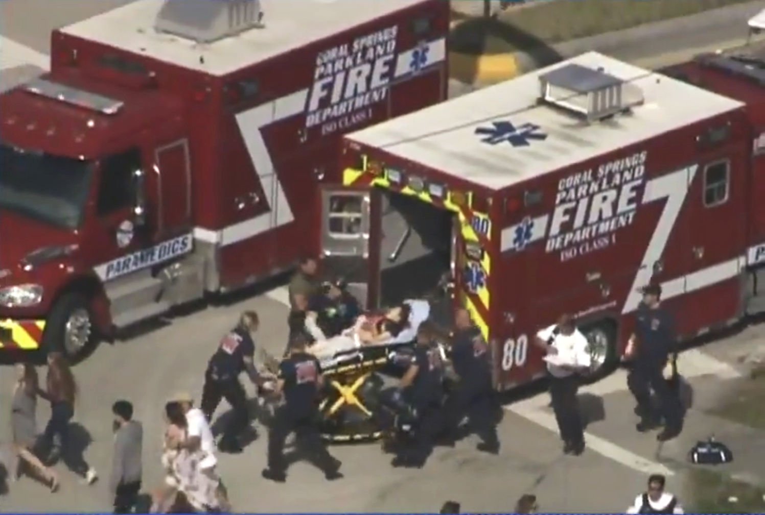 Rescue workers prepare to transport a victim on a stretcher near Marjory Stoneman Douglas High School following a mass shooting Feb. 14 in Parkland