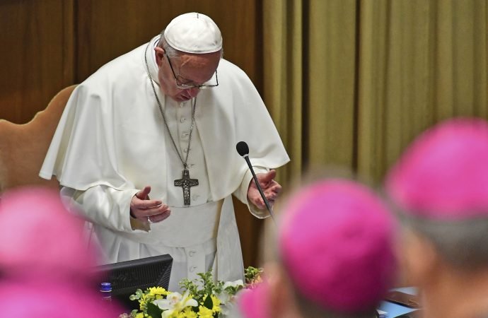 Pope Francis prays at the opening of a sex abuse prevention summit