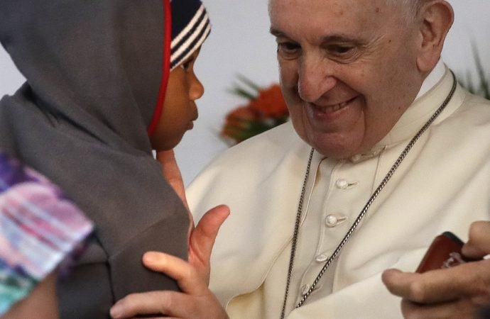 Pope Francis caresses a child during his visit at Zimpeto Hospital