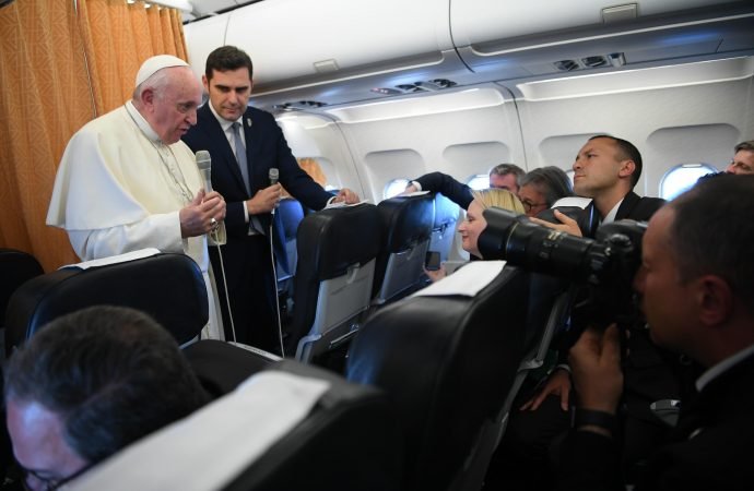 Pope Francis talks to reporters on his flight back to Rome
