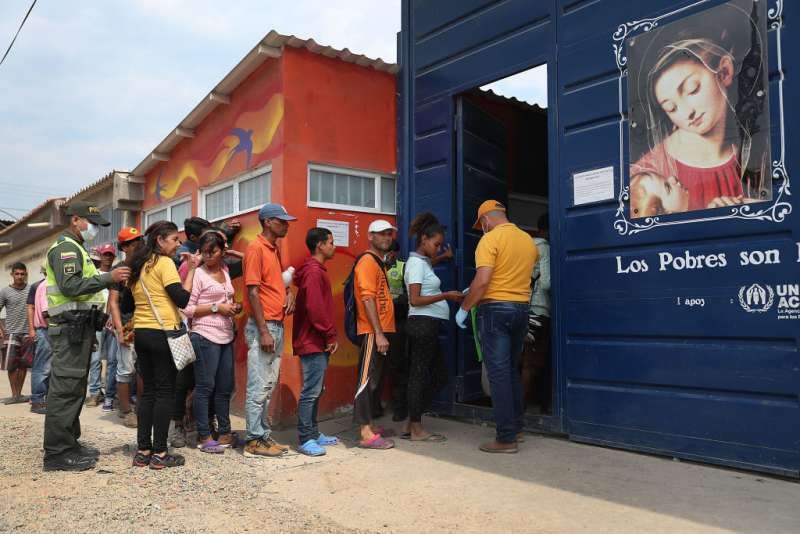 Venezuelan migrants waiting to enter the Divine Providence House in Cucuta