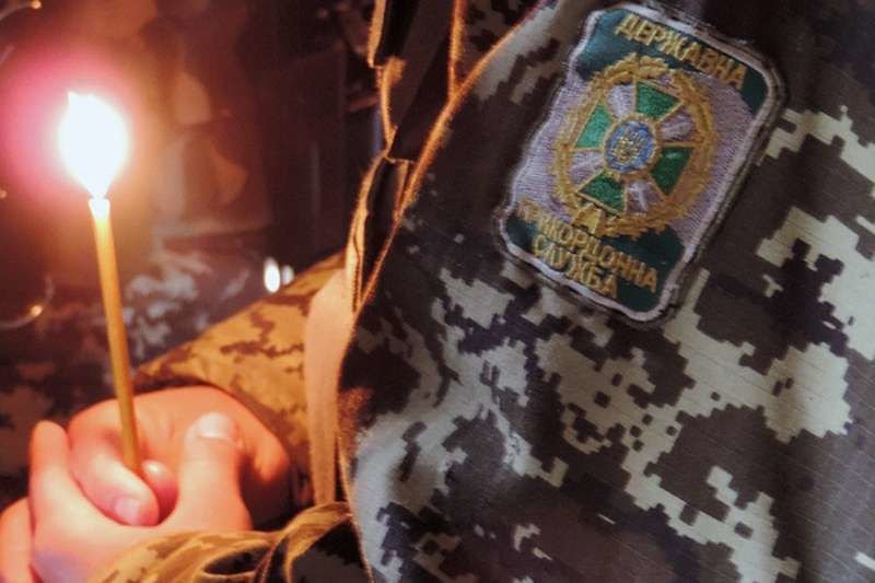 A soldier holds a prayer candle at a military chaplaincy in eastern Ukraine