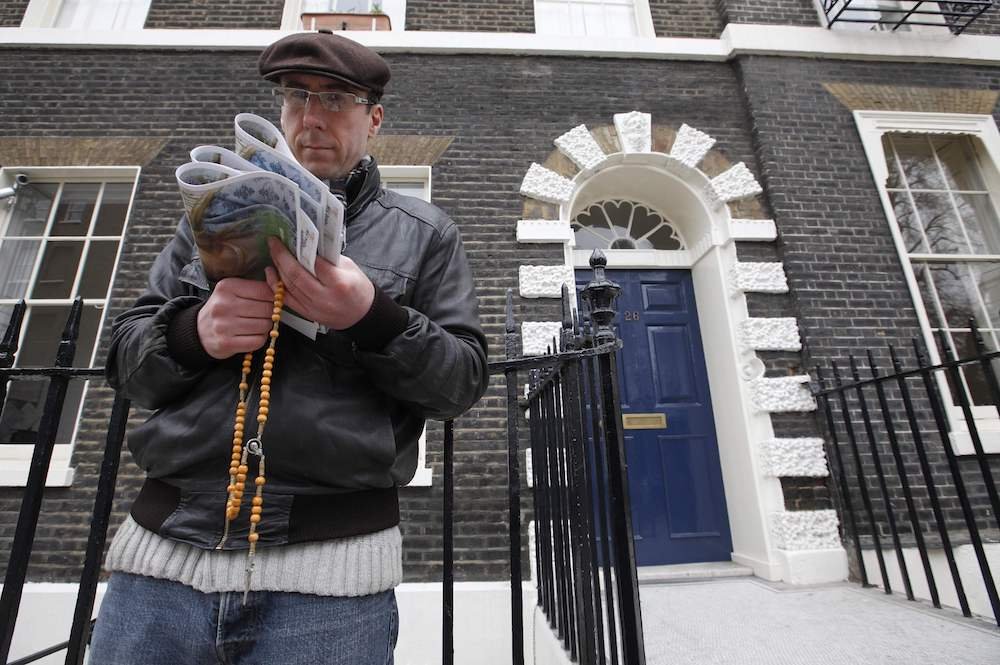 A pro-life activist holds a rosary outside an abortion clinic in 2012 in London. Auxiliary Bishop John Sherrington of Westminster praised a decision by the British government not to impose exclusion zones around abortion clinics throughout the country. (CNS photo/Andrew Winning