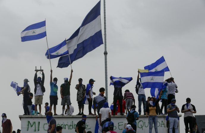 People fly Nicaraguan national flags during the commemoration of Student Day