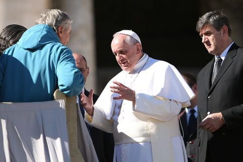 Pope Francis greets pilgrims inside St. Peter's Square during the Wednesday general audience on Feb. 11