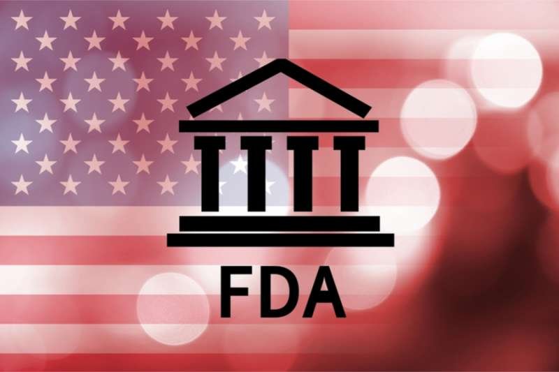 Building icon with inscription FDA and flag of The United States. Credit: g0d4ather_Shutterstock