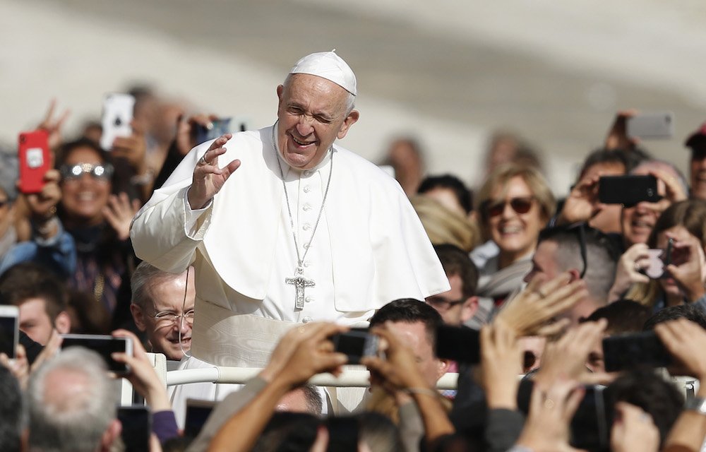 Pope Francis greets the crowd during his general audience in St. Peter's Square at the Vatican May 29