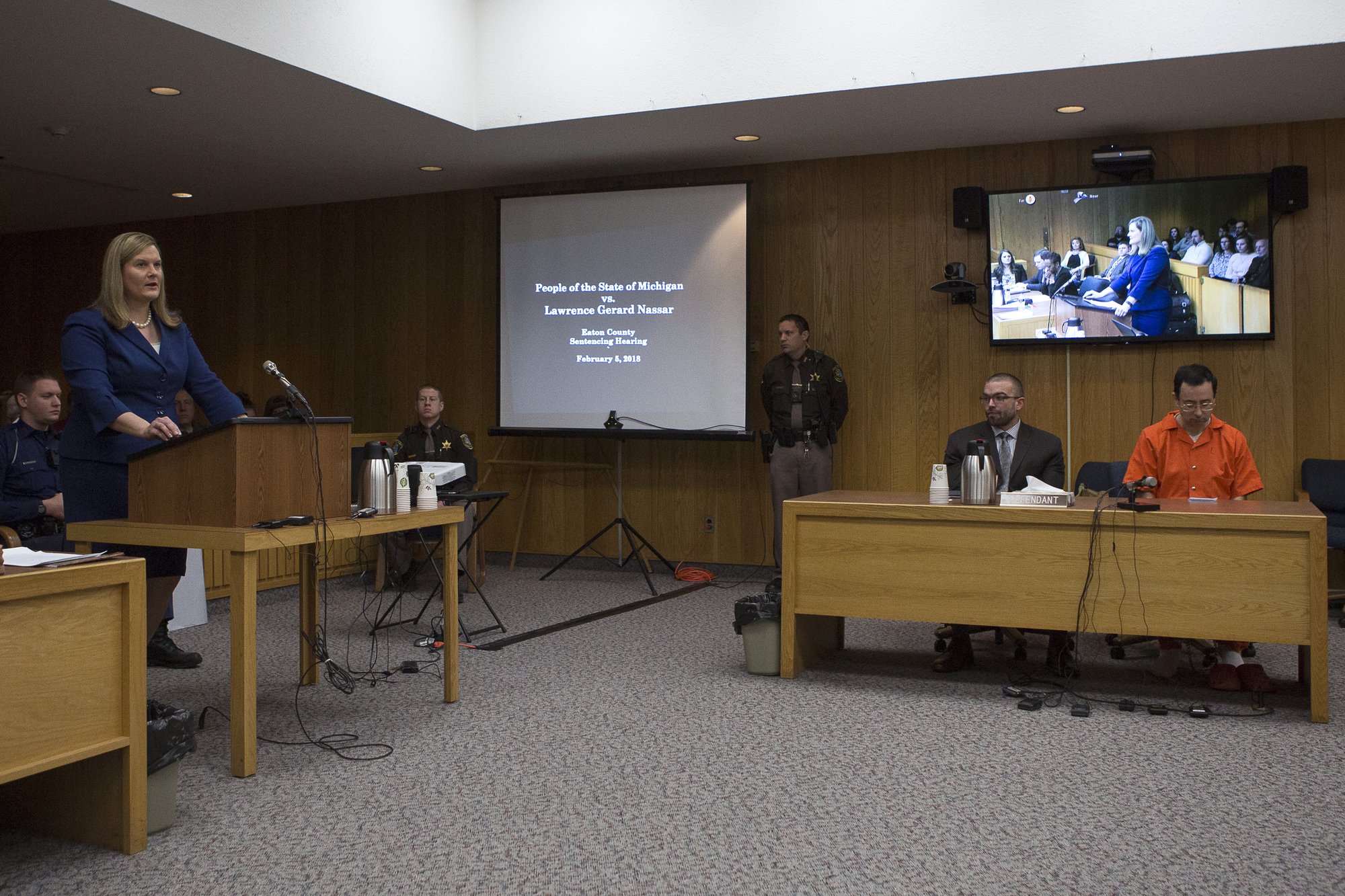 Michigan Assistant Attorney General Angela M. Povilaitis (L) gives her closing statements during the final sentencing phase of former Michigan State University and USA Gymnastics doctor Larry Nassar (R) in Eaton County Circuit Court on February 5