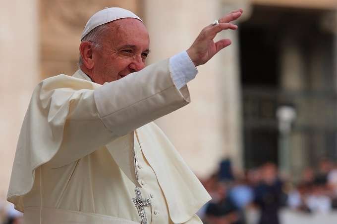 Pope Francis waves to pilgrims during his June 15