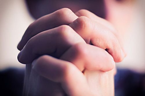 Praying. Credit: Champion studio via www.shutterstock.com.