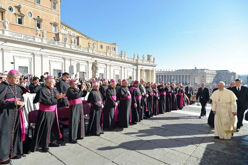 Pope Francis greets cardinals and bishops on Oct. 11