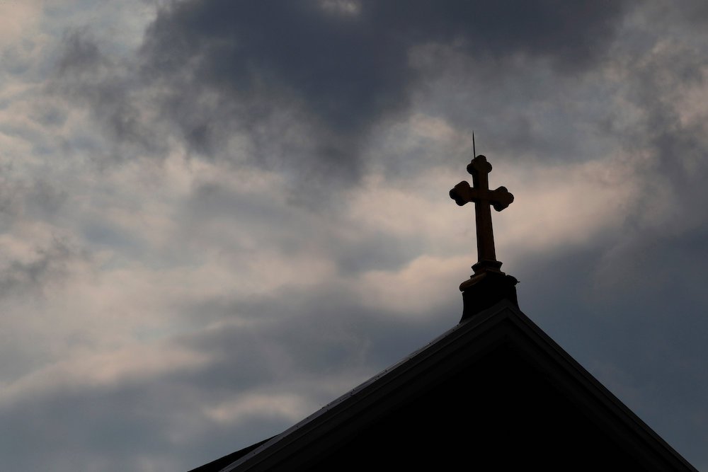 Storm clouds pass over a Catholic church in Pittsburgh. The Pennsylvania attorney general released a grand jury report Aug. 14