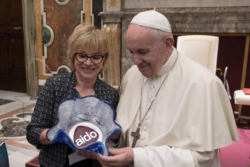 Pope Francis accepts a gift during an audience with members of the Italian Association of Organ Donors at the Vatican April 13