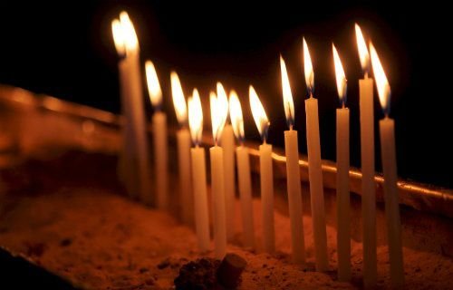 Candles lit in the Church of the Holy Sepulchre in Jerusalem