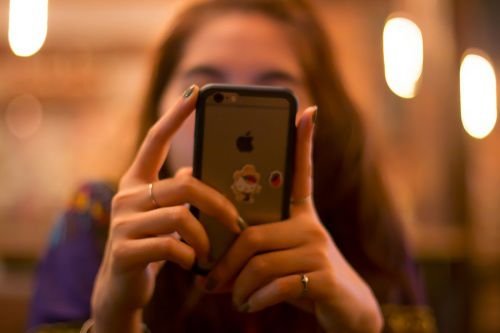 Woman on phone. Credit Danupol Noodam via www.shutterstock.com.