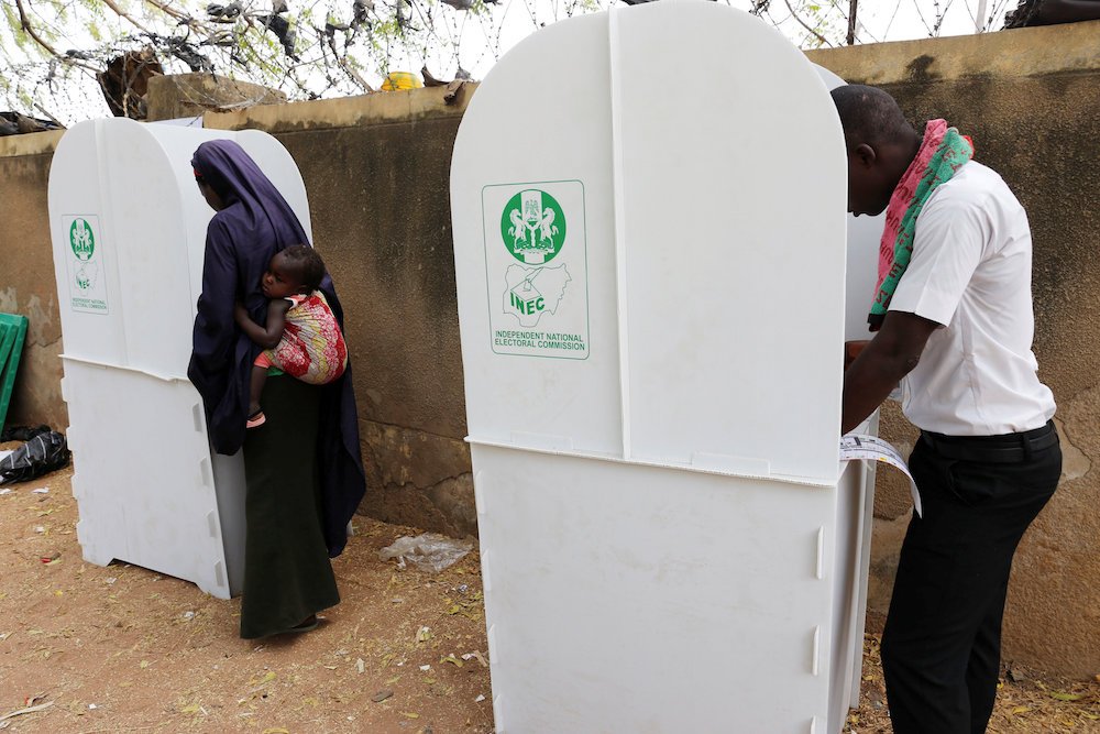 People cast their votes during Nigeria's presidential election at Capital School polling unit in Yola