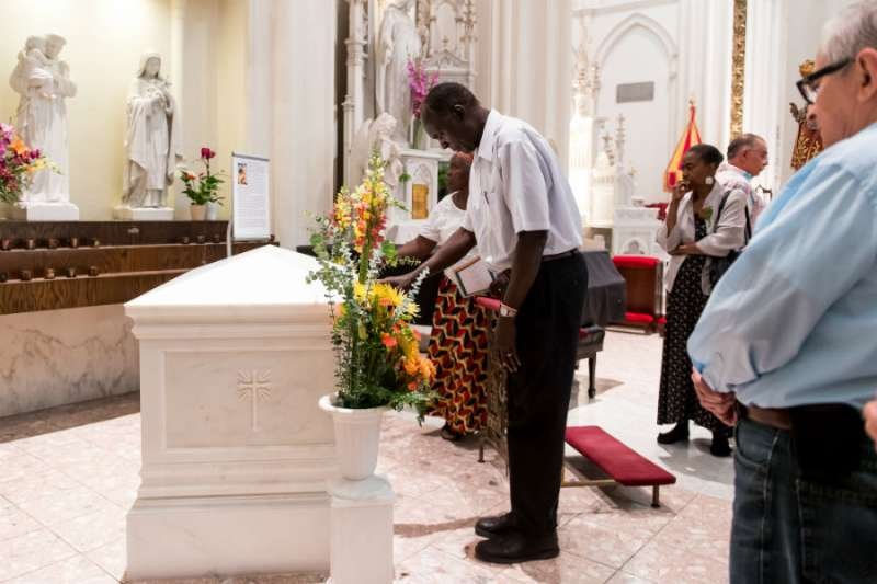 People pray before the tomb of Servant of God Julia Greeley following Mass on June 7