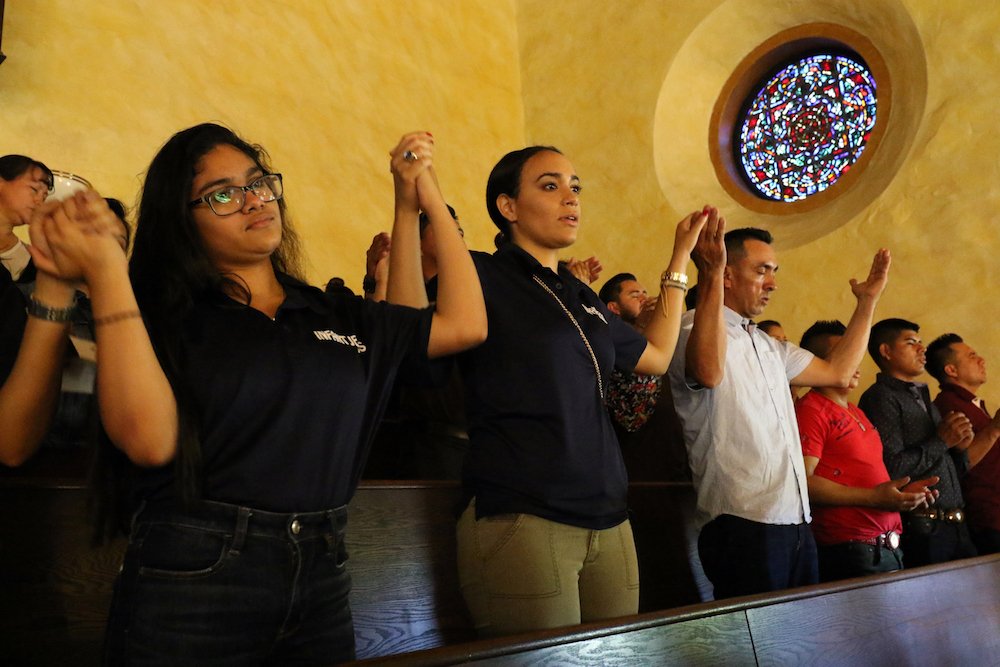 Participants recite the Lord's Prayer during Mass at the Labor Day Encuentro gathering at Immaculate Conception Seminary in Huntington
