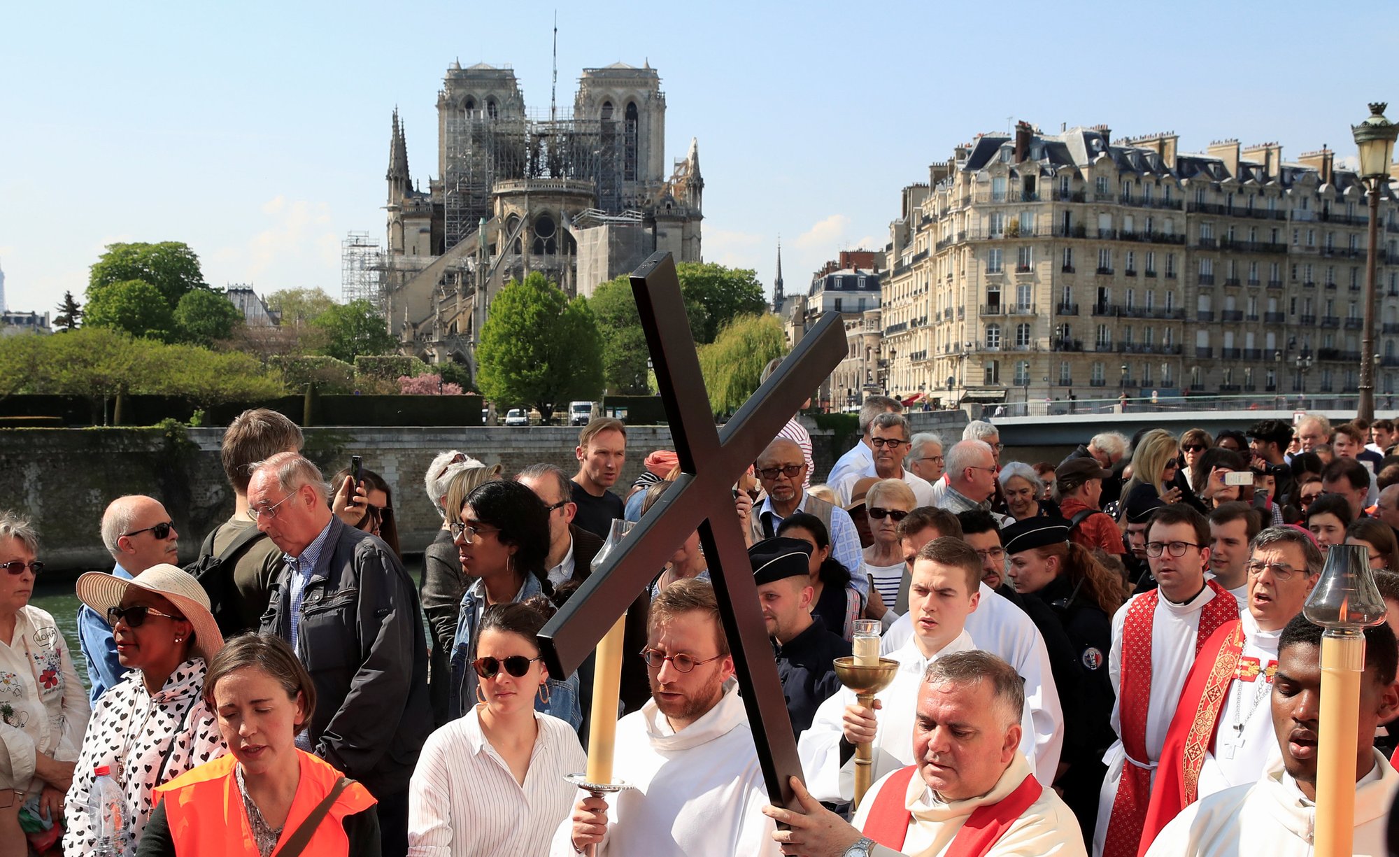 People in Paris attend a Good Friday Stations of the Cross procession April 19