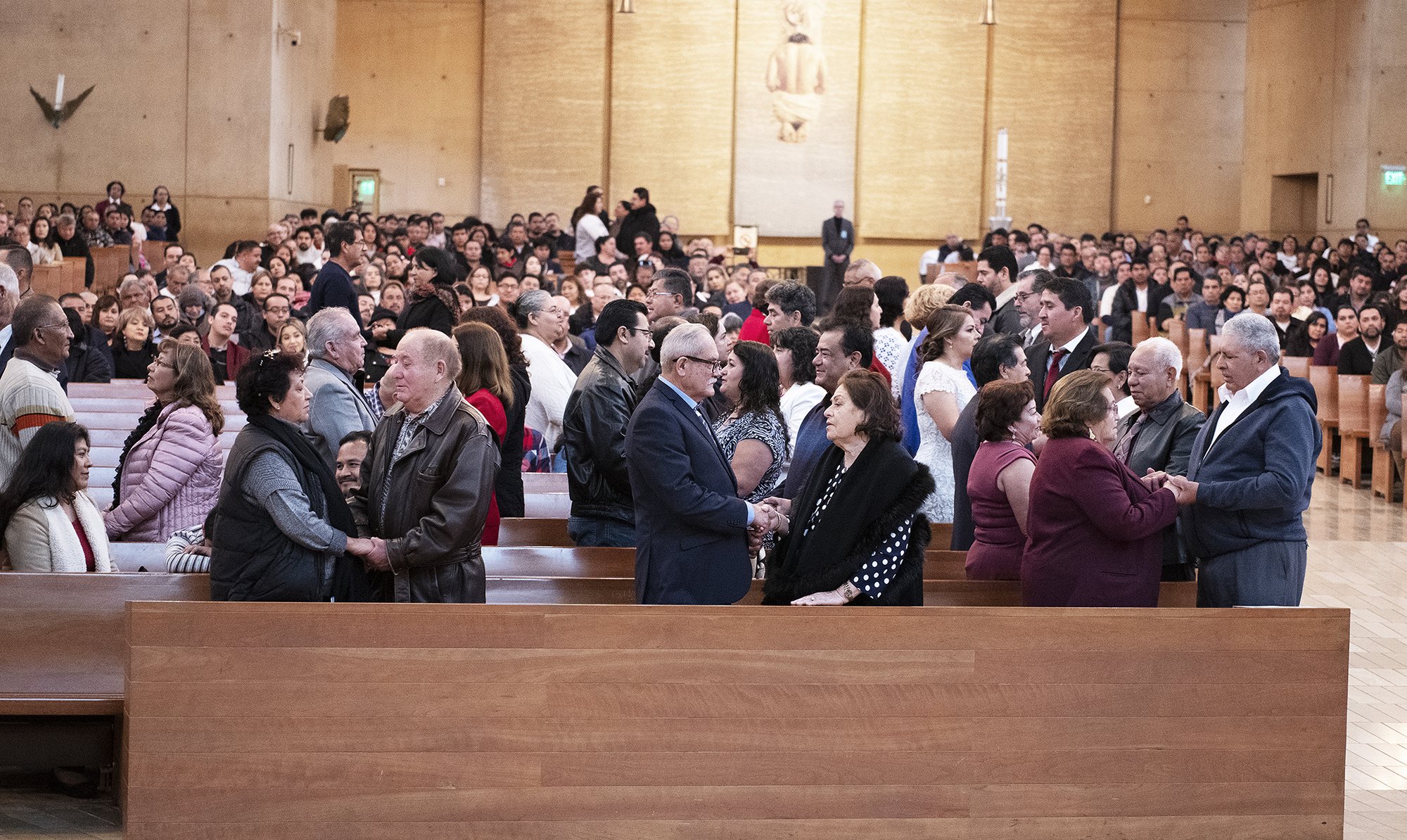 Couples offer the Sign of Peace at the World Marriage Day Mass