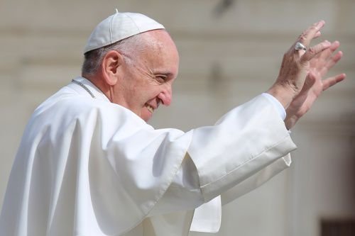 Pope Francis waves to pilgrims during his May 25