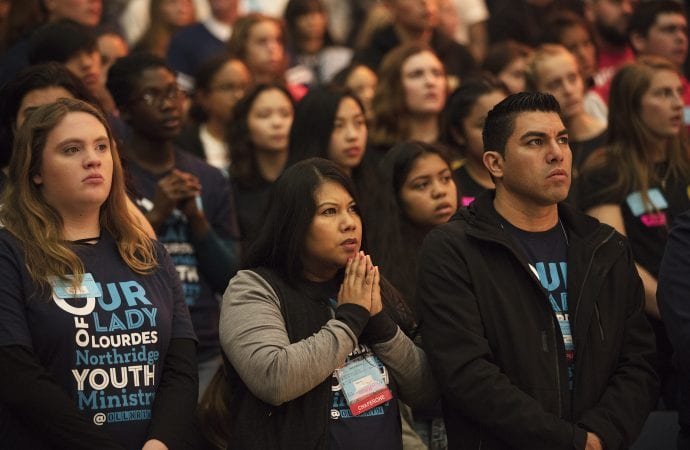 Young people pray during the Youth Day portion of the 2018 Religious Education Congress at the Anaheim Convention Center in California. More than 15