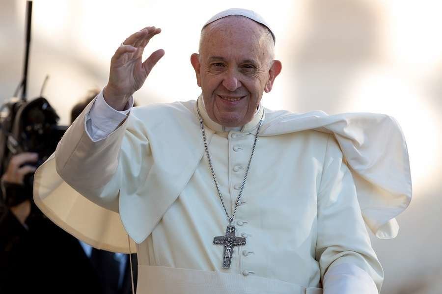 Pope Francis waves to pilgrims during his Oct. 25