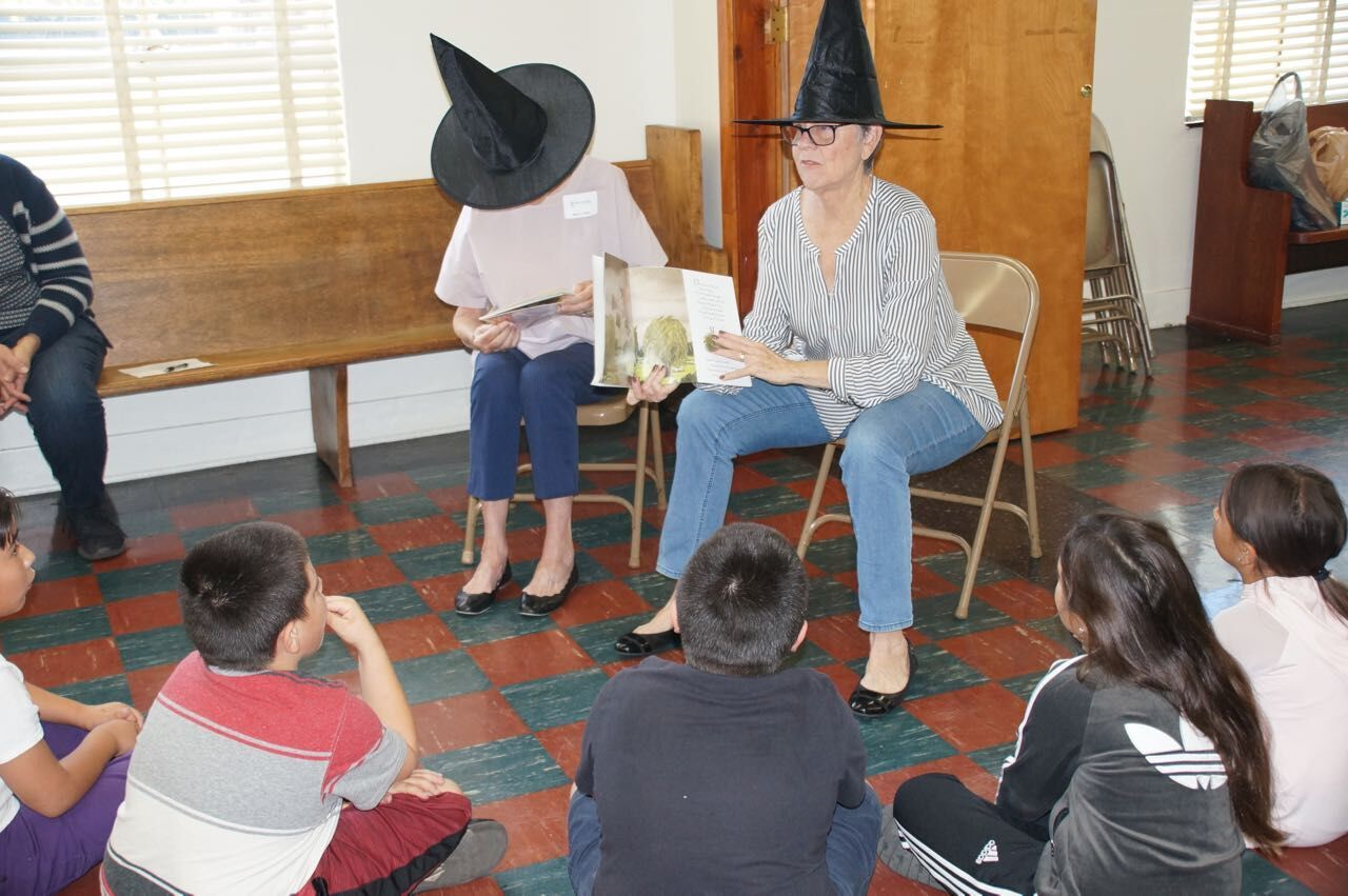 Christ Child member Patty Smith reads "Room on the Broom" to Sacred Heart religious education students at the Pasadena chapter's Day of Service Oct. 27. (PHOTO COURTESY PASADENA CHRIST CHILD SOCIETY)