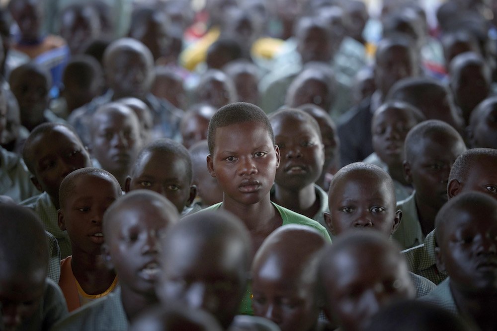 Children attend Mass in late April in Lugi