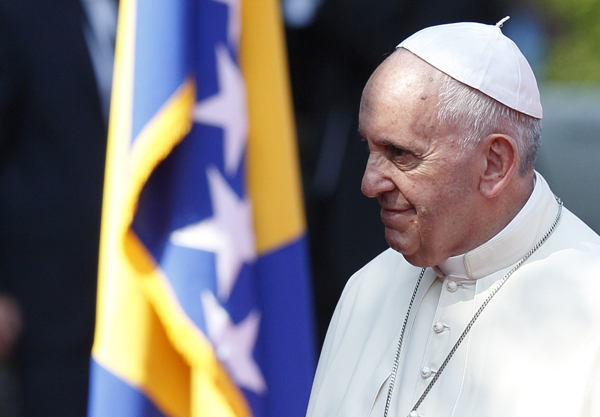 Pope Francis is pictured near Bosnia-Herzegovina's flag during a welcoming ceremony at the presidential palace in Sarajevo