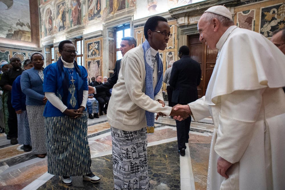 Pope Francis greets a woman during an audience with members of the Missionaries of Africa and the Missionaries of Our Lady of Africa at the Vatican Feb. 8
