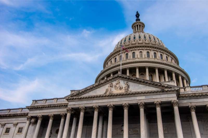 American flag flies on roof of United States capital. Credit: PhilipR_Shutterstock