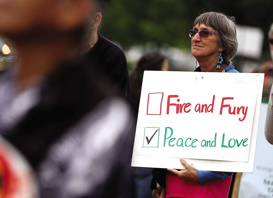 A protester holds a sign during a demonstration against nuclear weapons outside of the Lawrence Livermore National Laboratory on August 9