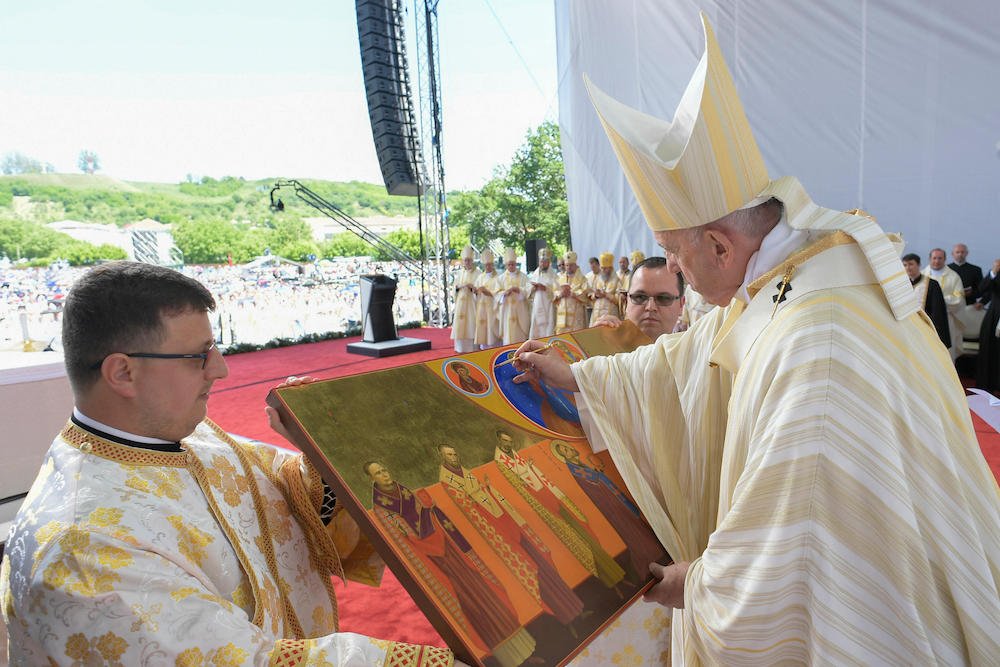 Pope Francis marks an icon of seven martyred bishops of the Eastern-rite Romanian Catholic Church during their beatification at a Divine Liturgy at Liberty Field in Blaj