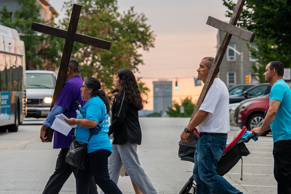 People take part in the refugee-themed Stations of the Cross in Baltimore July 23
