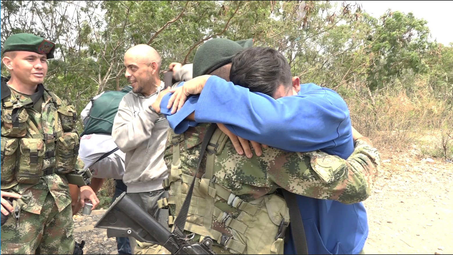 Pvt. Andry Rosales hugs a Colombian soldier after defecting from Venezuela Feb. 27
