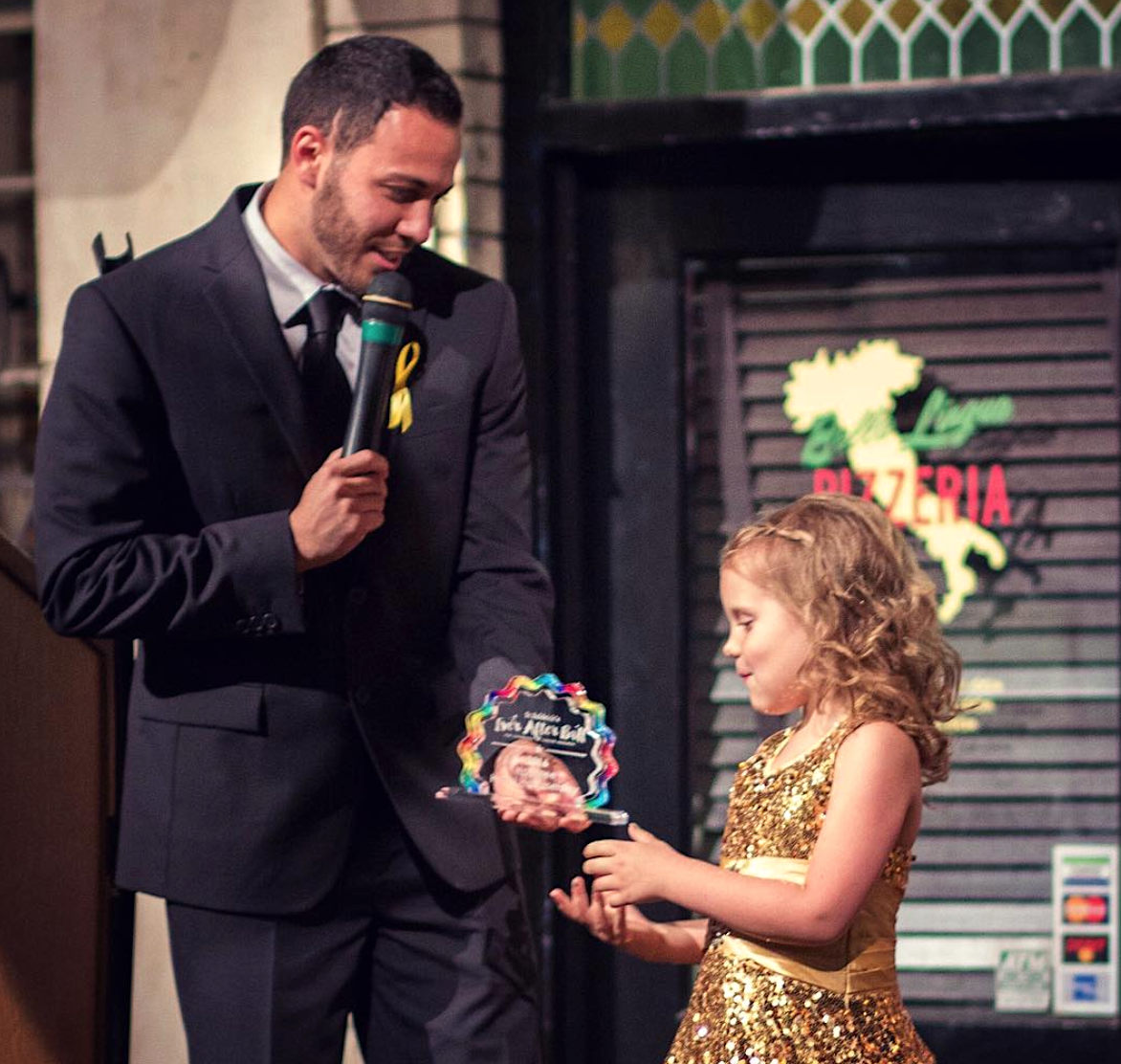 Vinny Fasline delivers an award to a cancer survivor during the St. Baldrick's Ever After Ball fundraiser in 2017. (IMAGE VIA INSTAGRAM @VINNYFASLINE)