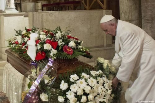 Pope Francis lays a bouquet on Vatican employee Miriam Wuolou's coffin Feb. 20
