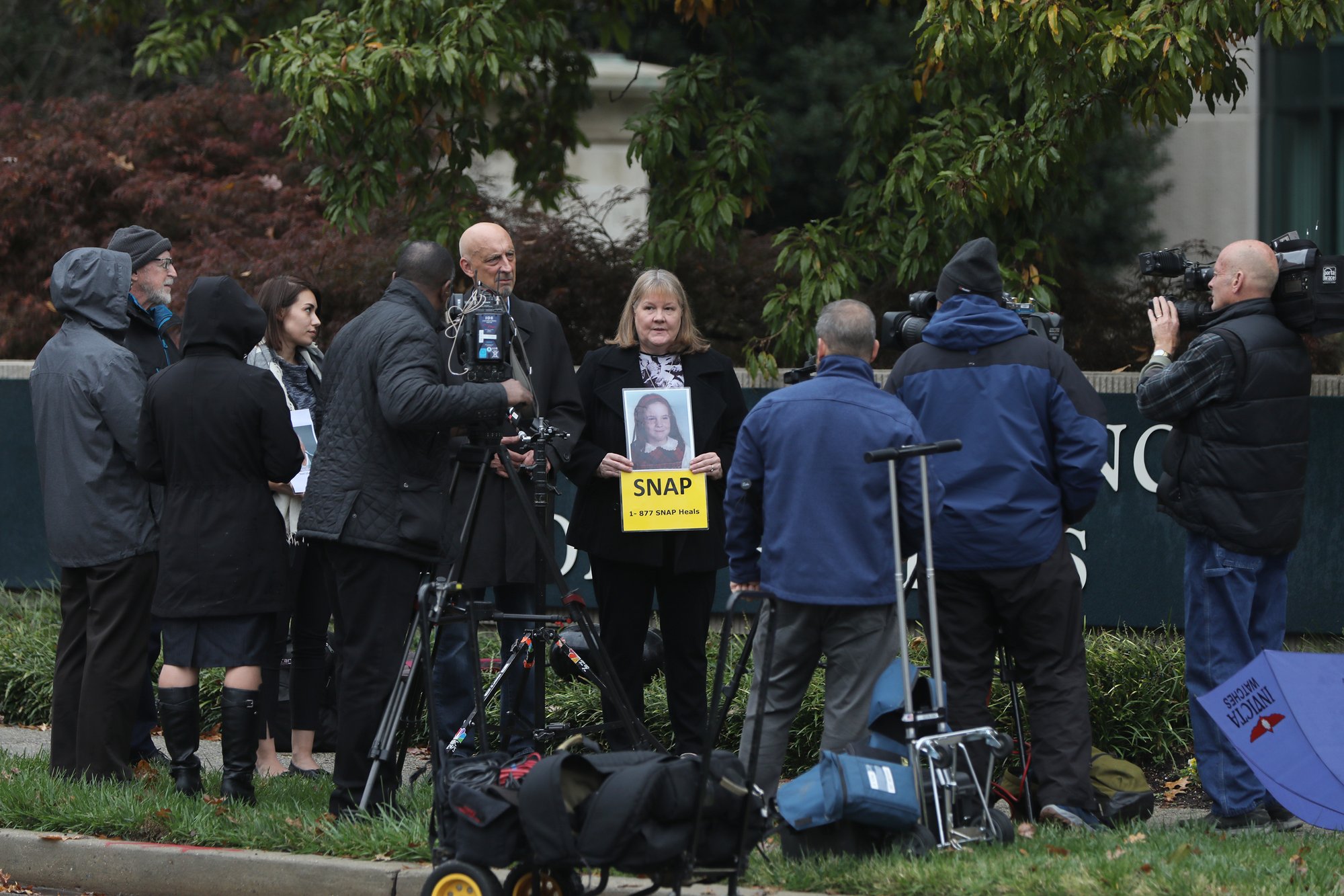 Members of the media are seen during a protest by the Survivors Network of those Abused by Priests